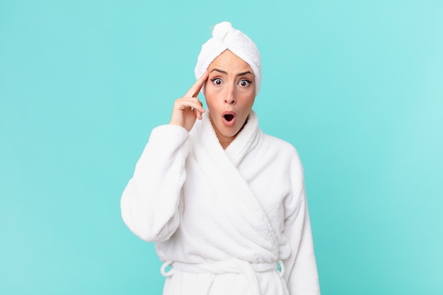 Young blonde woman looking surprised, realizing a new thought, idea or concept. shower concept.