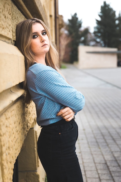 Young blonde woman outside on the street