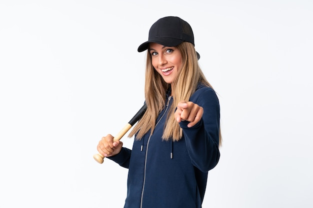 Young blonde woman playing baseball