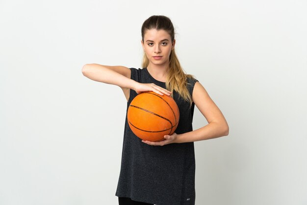 Young blonde woman over playing basketball