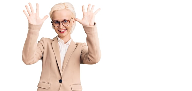 Young blonde woman wearing business clothes and glasses showing and pointing up with fingers number ten while smiling confident and happy