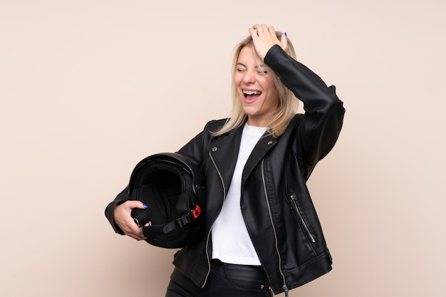 Young blonde woman with a motorcycle helmet has realized something and intending the solution