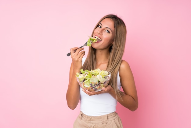 Young blonde woman with salad