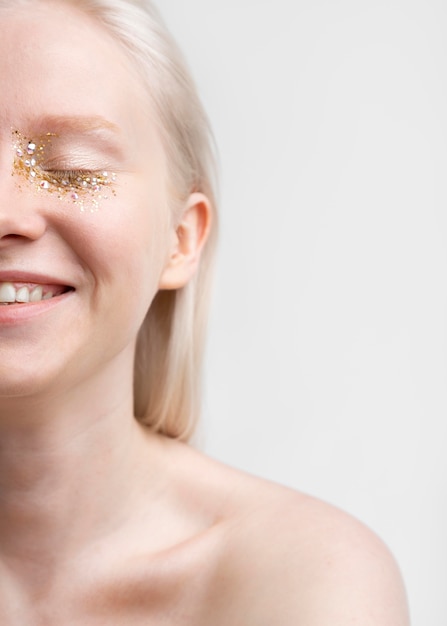 Young blonde woman with shiny make-up portrait