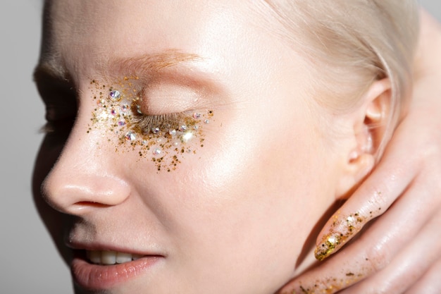 Young blonde woman with shiny make-up portrait