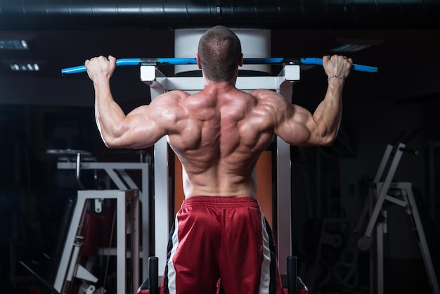 Young Bodybuilder Doing Heavy Weight Exercise For Back