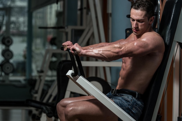 Young Bodybuilder Doing Heavy Weight Exercise For Chest