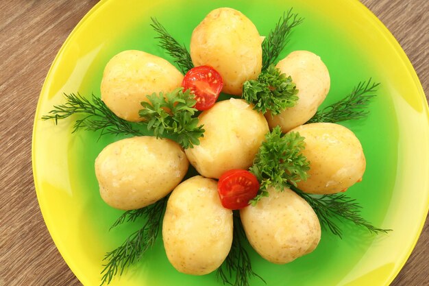 Young boiled potatoes on table close up