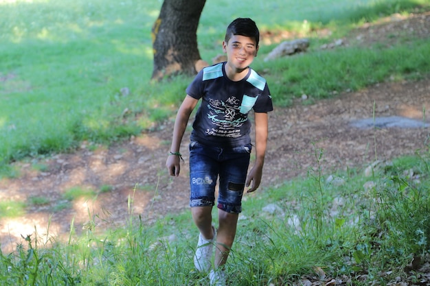 young boy beautiful on a camping trip in the forest summer background