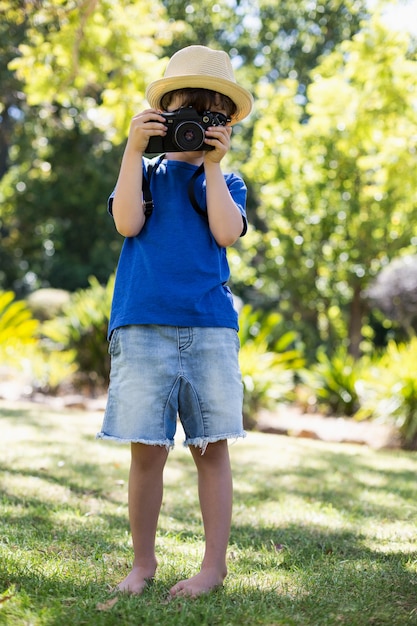 Young boy clicking a photograph from camera