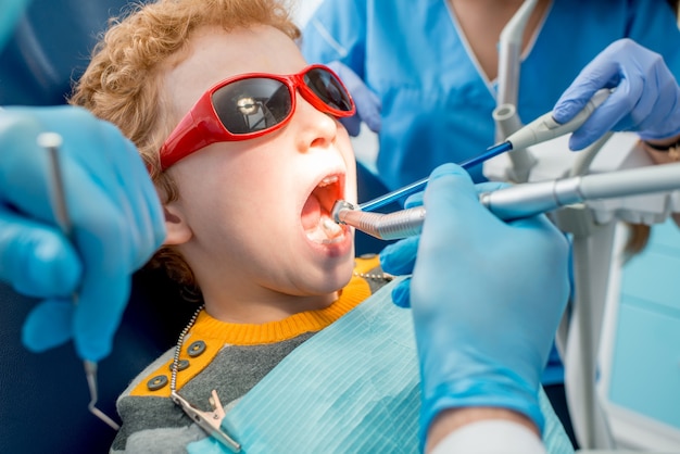 Young boy during the dental procedure at the dental office