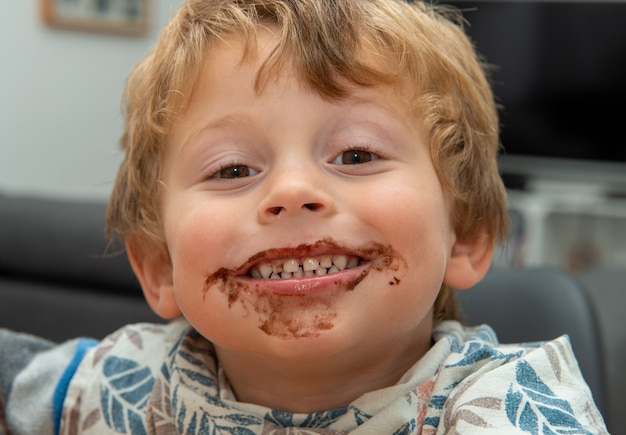 Young boy eating a chocolate ice cream