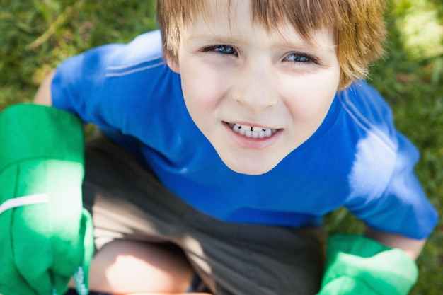 Young boy in gardening gloves at park