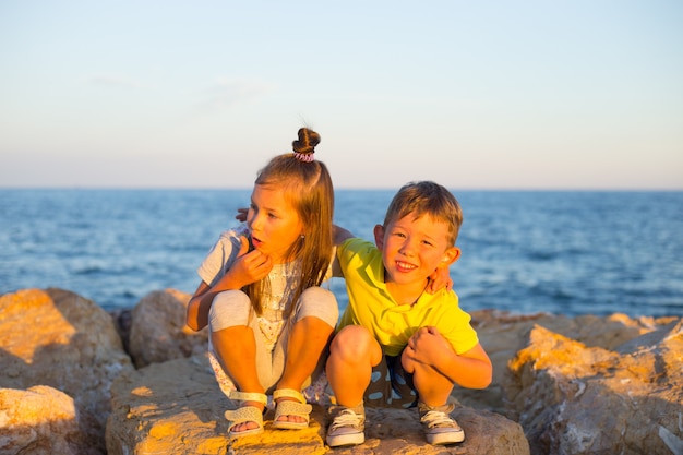 Young boy and girl near the ocean on a summer day