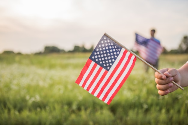 Young boy holding an American flag in his hand