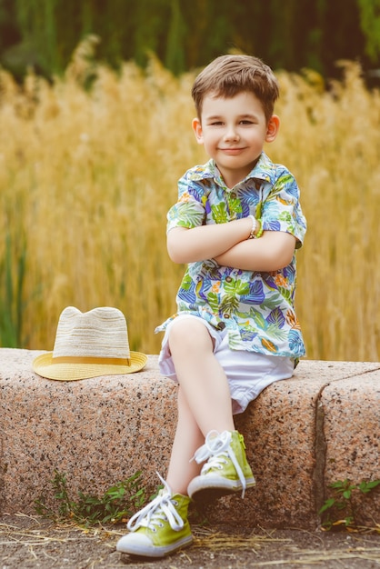 Young boy posing over stone background.