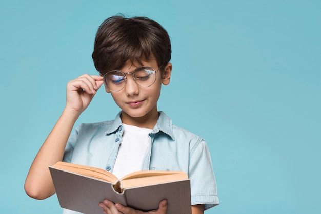 Young boy reading with copy-space