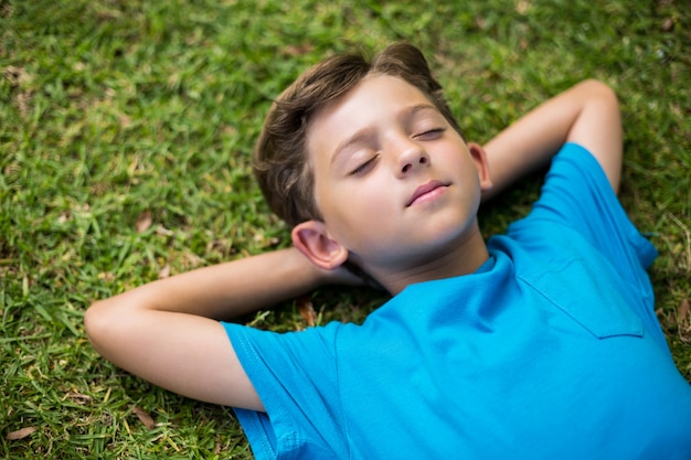 Young boy sleeping in park