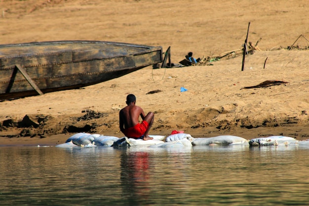 A young boy or teenage is doing his routine household work.