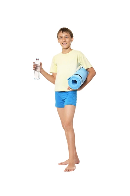 Young boy with bottle of water and mat