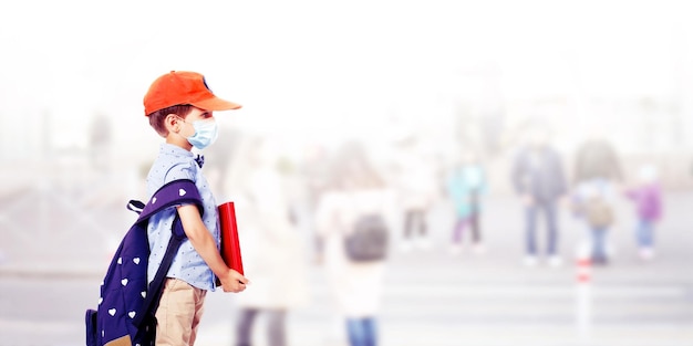 Young boy with protection mask against corona virus at school