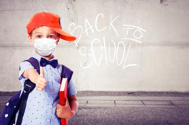 Young boy with protection mask against corona virus at school