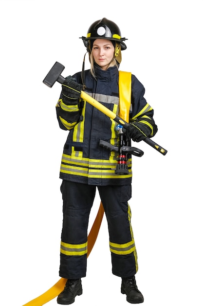 Young brave woman in uniform of firefighter with fire hose and sledgehammer