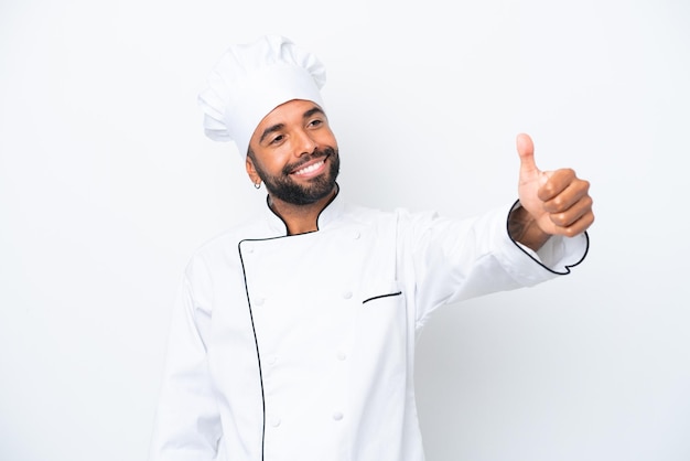 Young Brazilian chef man isolated on white background giving a thumbs up gesture