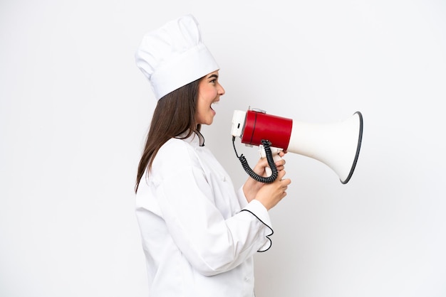 Young Brazilian chef woman isolated on white background shouting through a megaphone