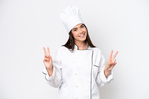 Young Brazilian chef woman isolated on white background showing victory sign with both hands