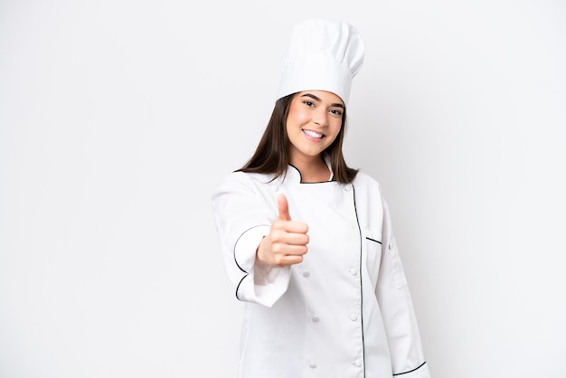 Young Brazilian chef woman isolated on white background with thumbs up because something good has happened