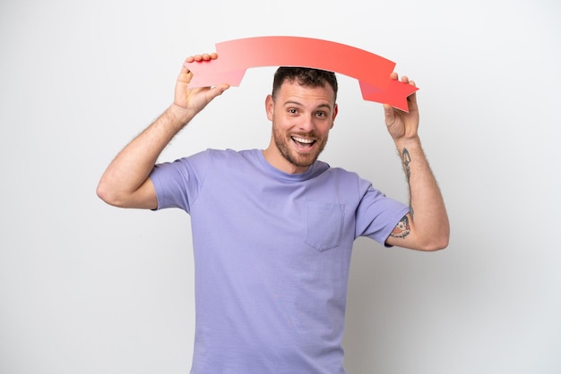 Young Brazilian man isolated on white background holding an empty placard