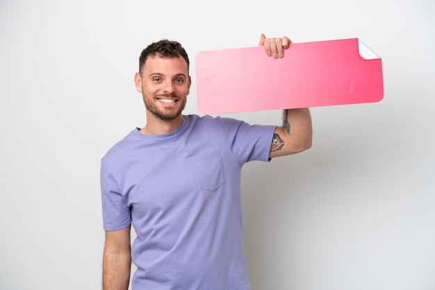 Photo young brazilian man isolated on white background holding an empty placard