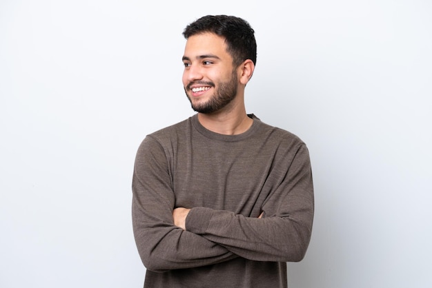 Young Brazilian man isolated on white background looking to the side