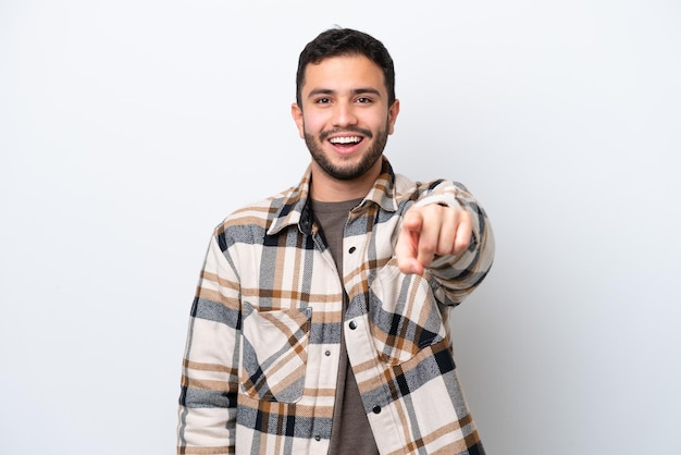 Young Brazilian man isolated on white background surprised and pointing front