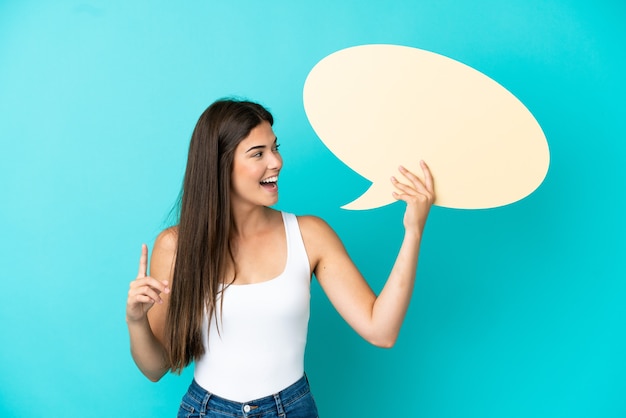 Young Brazilian woman isolated on blue background holding an empty speech bubble and thinking