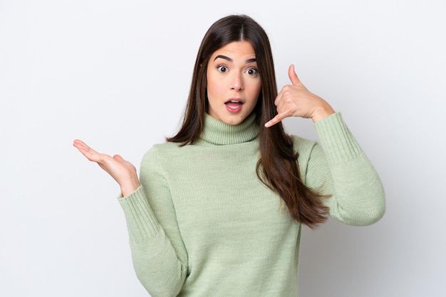 Young Brazilian woman isolated on white background making phone gesture and doubting