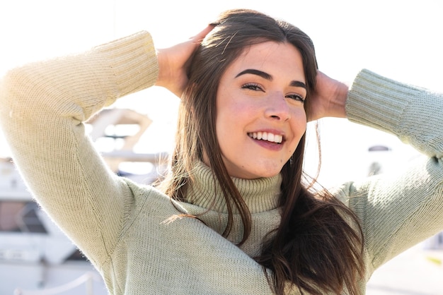 Young Brazilian woman at outdoors With happy expression