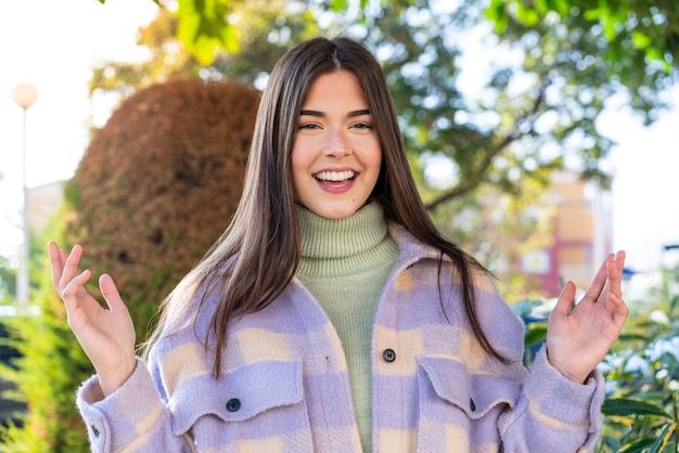 Young Brazilian woman in a park smiling a lot