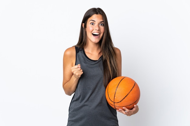 Young brazilian woman playing basketball isolated