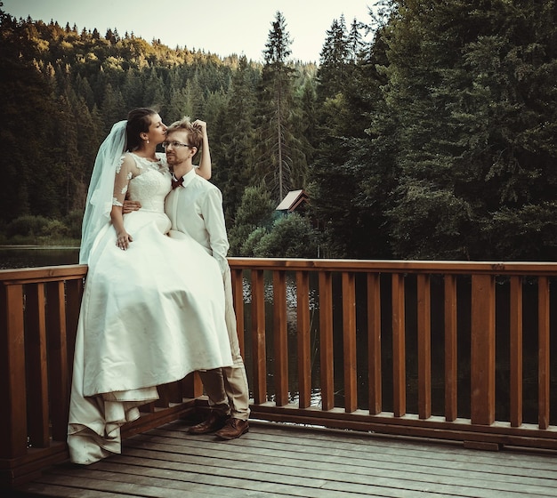 A young bride and groom standing together outdoor summer time