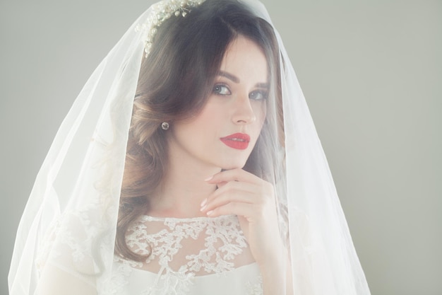 Young bride woman in veil face closeup portrait