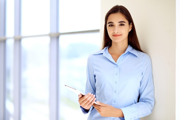 Young brunette businesswoman or student girl looking at camera