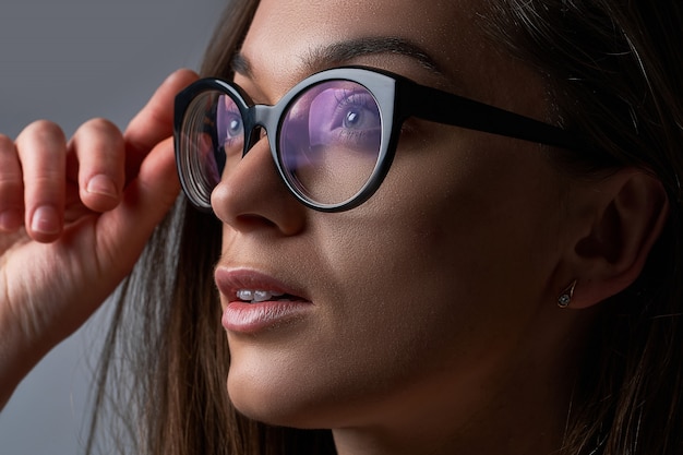 Young brunette caucasian female wearing black frame glasses for vision