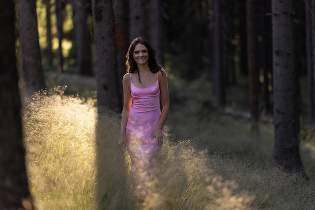 Young brunette girl walking through the forest