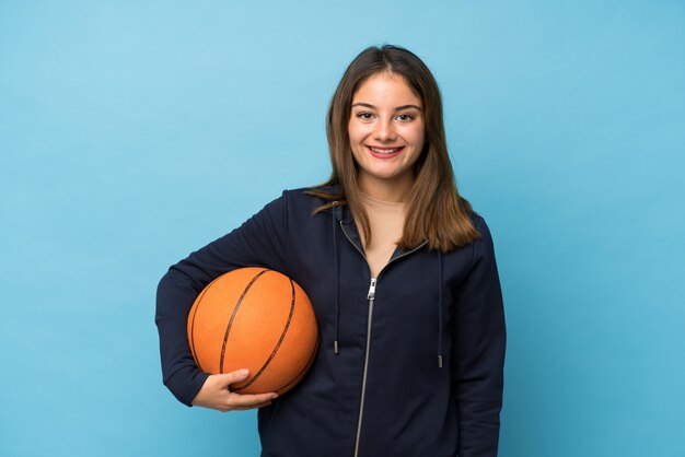 Young brunette girl with ball of basketball