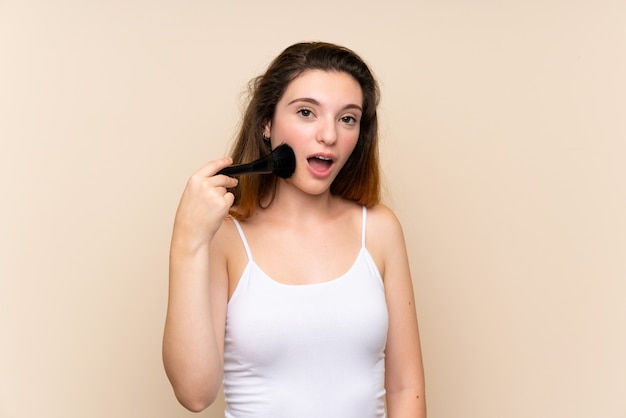 Young brunette girl with makeup brush 