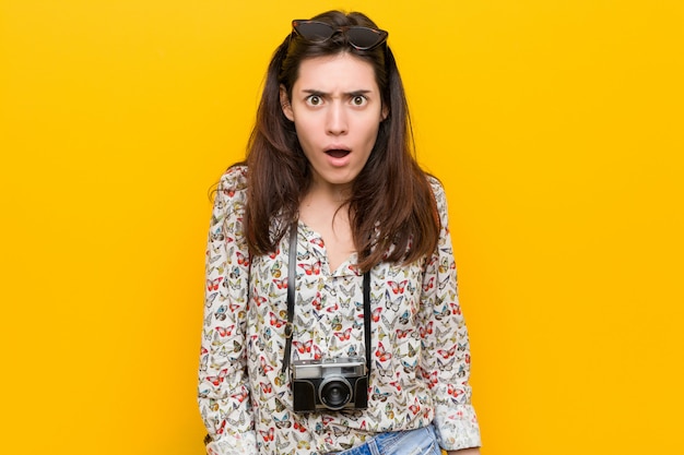 Young brunette traveler woman screaming very angry and aggressive.