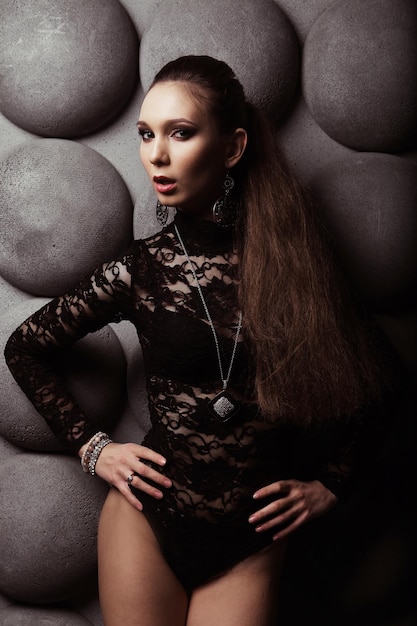 Young brunette woman dancing over modern background