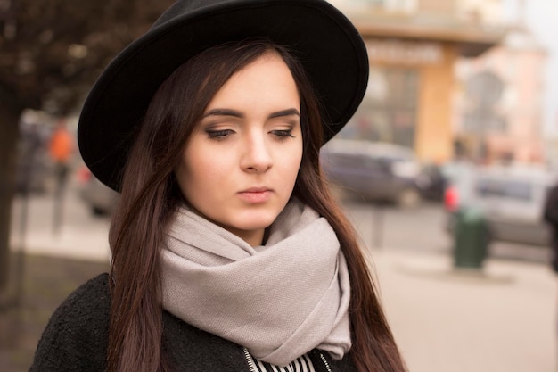 Young brunette woman in hat closeup